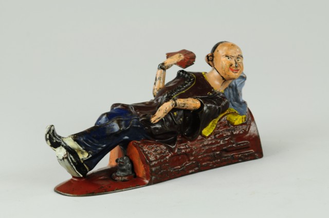 RECLINING CHINAMAN MECHANICAL BANK