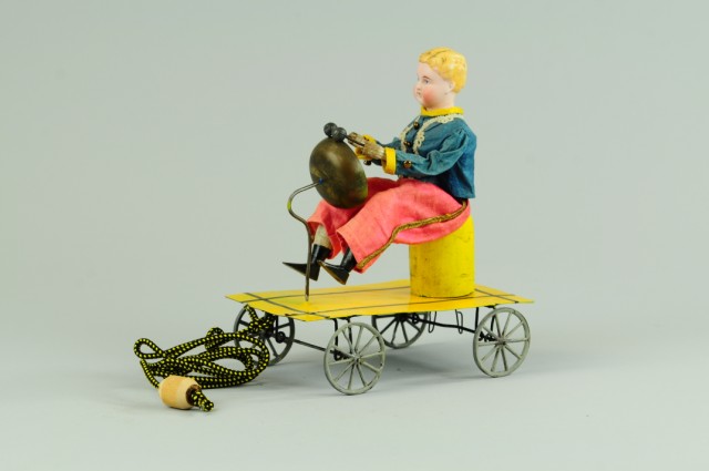 BOY ON CART BELL RINGER Pull toy features