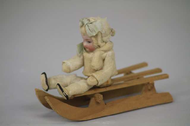 BISQUE HEAD BABY ON WOOD SLED CANDY