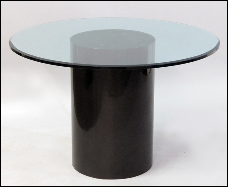 GLASS ROUND TOP TABLE. Raised on