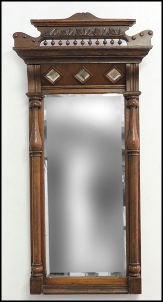 EASTLAKE STYLE CARVED WALNUT MIRROR.