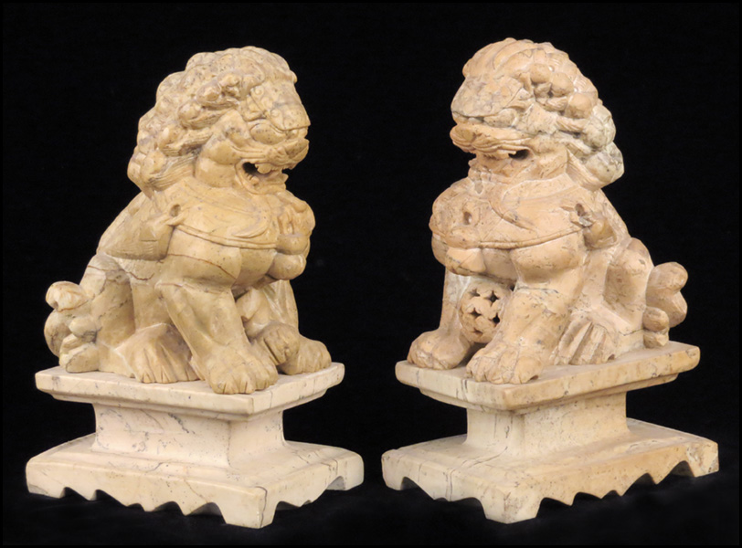 PAIR OF CARVED STONE FOO DOGS.