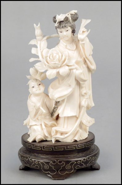 CARVED IVORY OF A MOTHER AND CHILD.