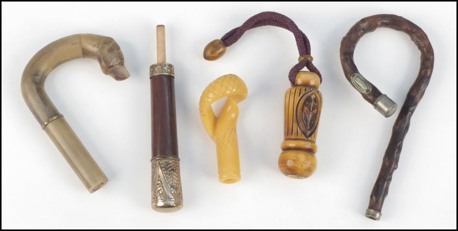 GROUP OF CANE HANDLES. Condition: