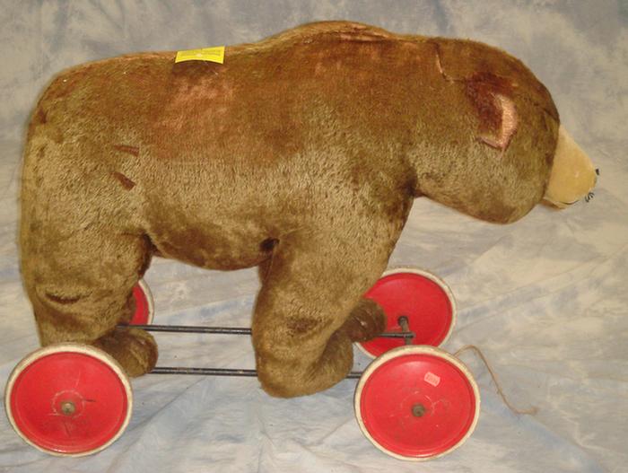 Plush bear pull toy on wheeled metal
