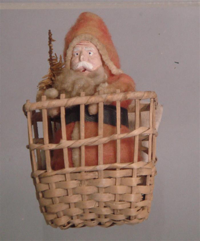 Paper mache Santa in basket, red felt
