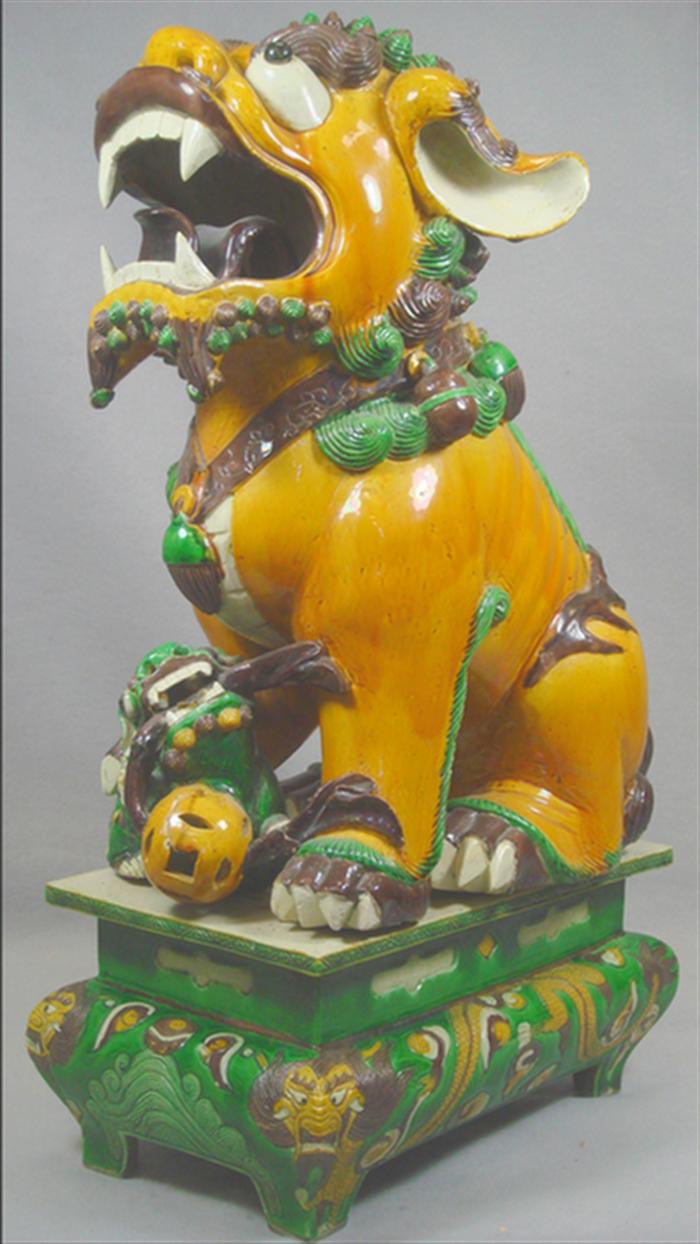 Chinese pottery foo dog on pedestal,
