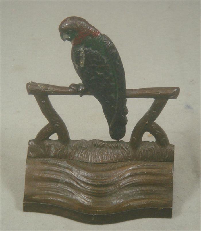 Cast iron doorstop bird on a perch  3c593