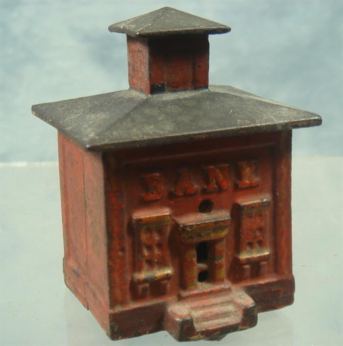 Cast iron coin bank, small red miniature
