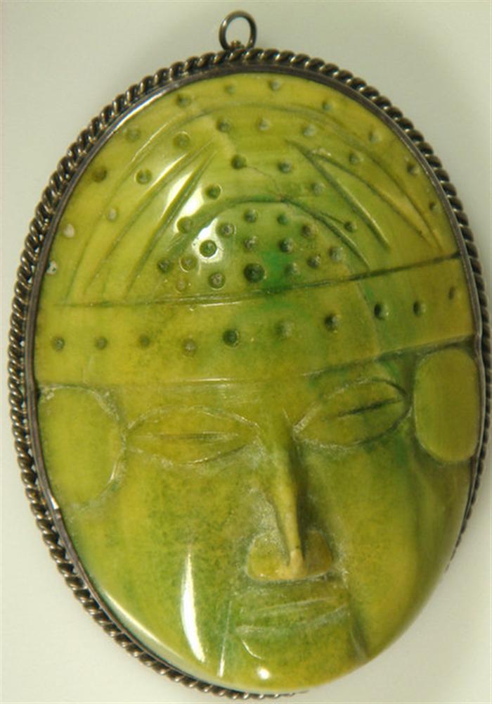 Carved green stone face pin in 3cda5