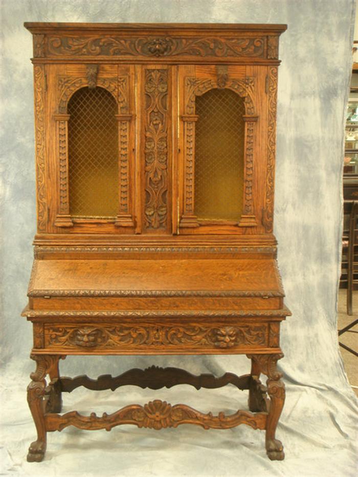 Two piece carved oak secretary