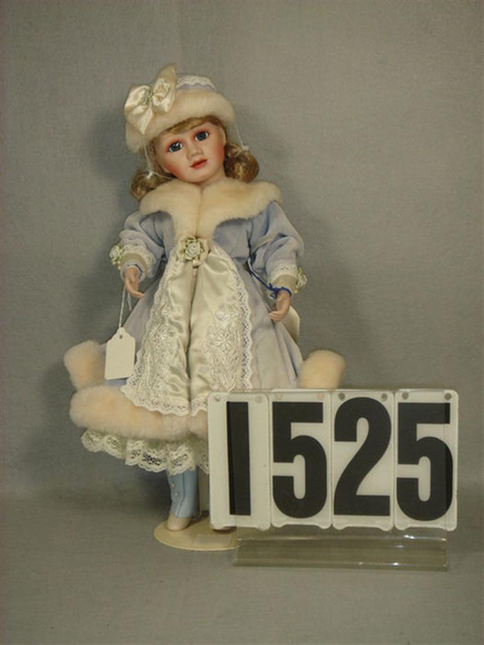 16 Porcelain and cloth doll wearing 3d24a