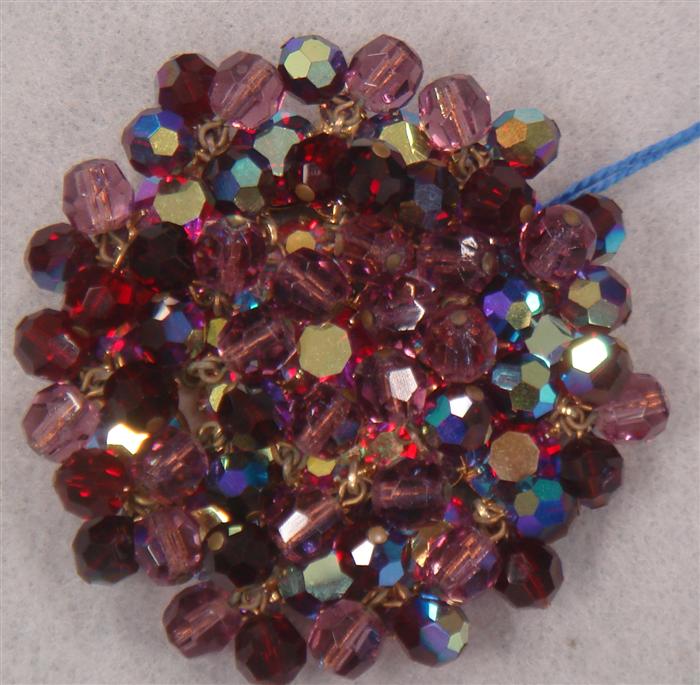 Ruby red iridescent stone brooch