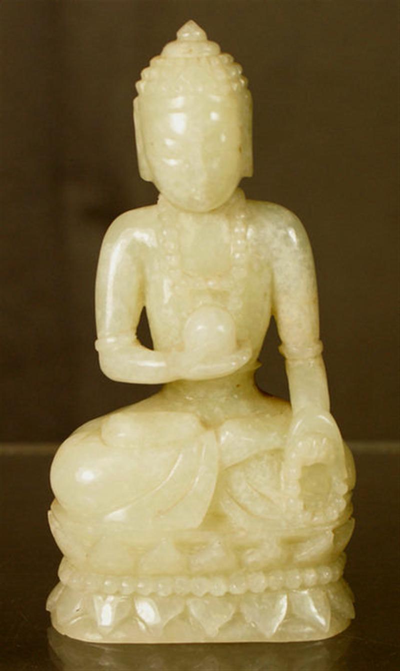 Carved light green jadeite seated