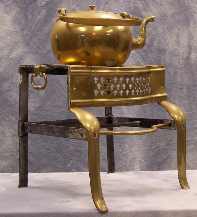 Brass tea kettle on brass and steel