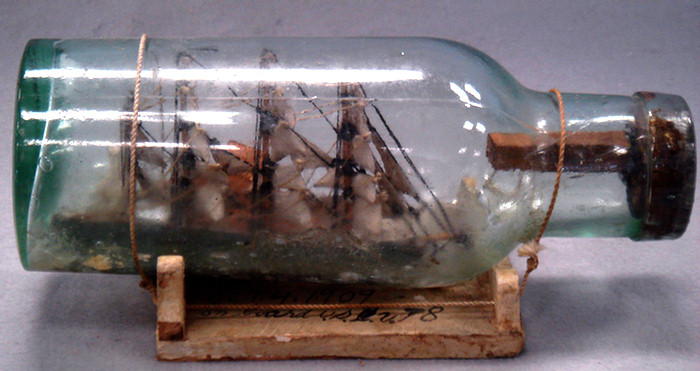 Folk art ship in a bottle, with