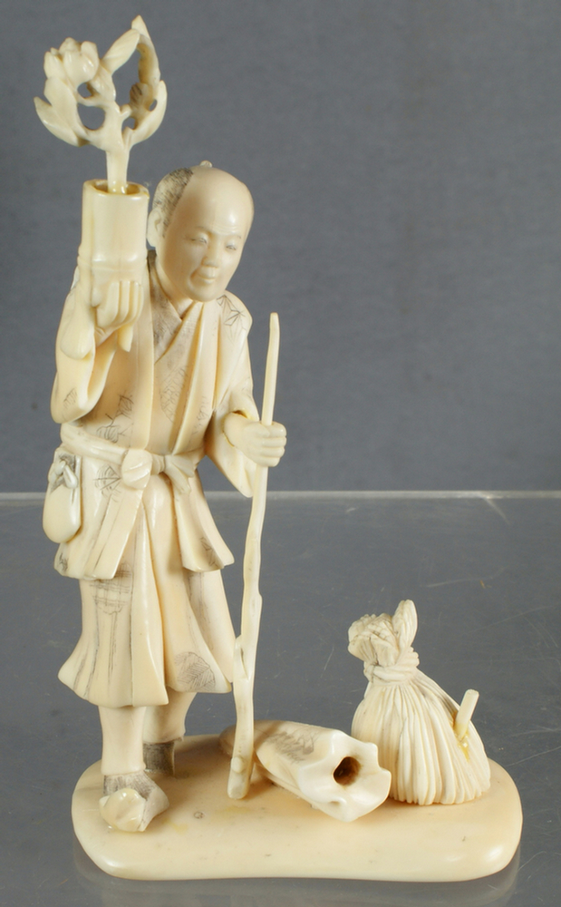 Carved ivory Japanese man holding 3e3b7