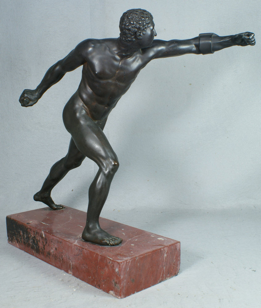 Bronze sculpture of a nude athlete on