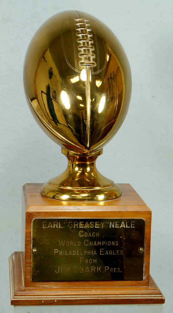 1949 NFL brass trophy football, on walnut