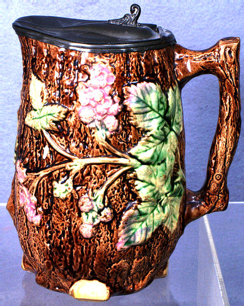 Majolica pitcher with pewter lid,