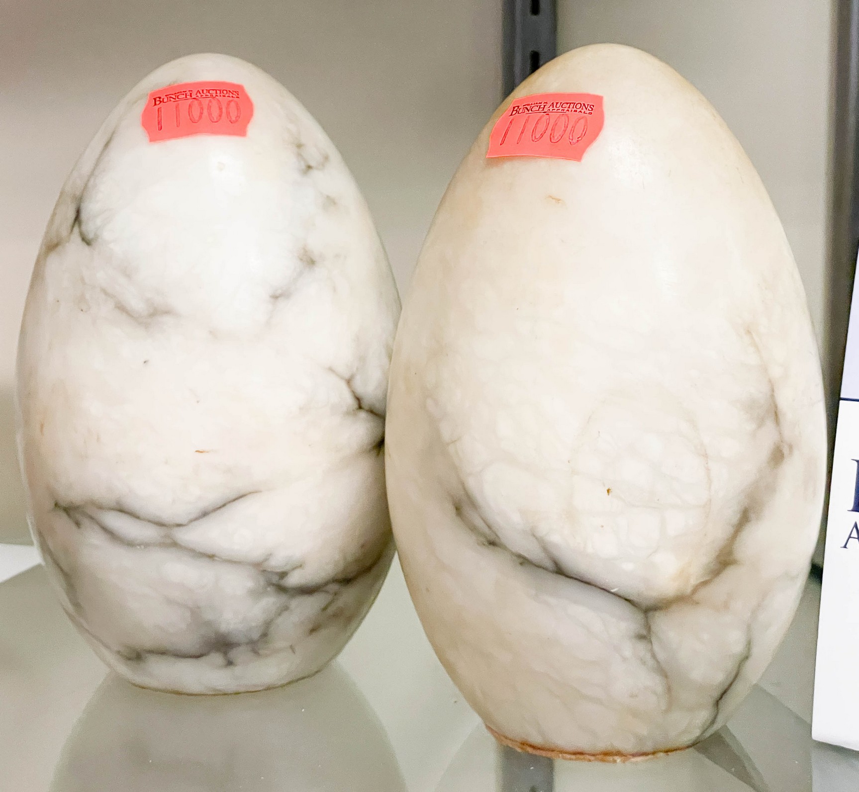 Pair of egg shaped bookends, white marble