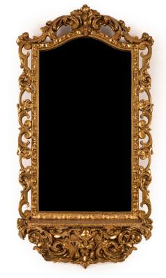A gilt framed hall mirror, the arched