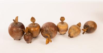 Seven treen pieces of fruit, each with