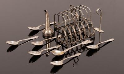 Two silver toast racks, six feather