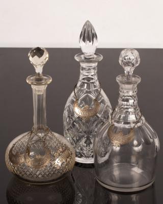 Three cut glass decanters with three