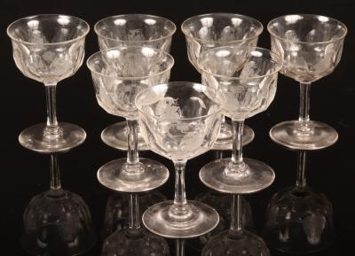 Seven wine glasses with etched