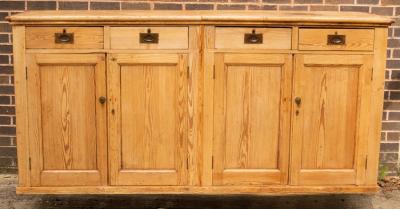 A pine cupboard enclosed by a pair of