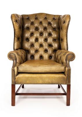 A wingback armchair upholstered in green