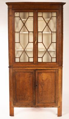 An oak floor standing corner cabinet,