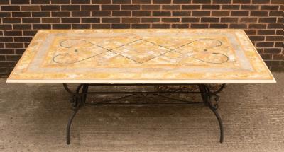 An inlaid stone top table on metal support,