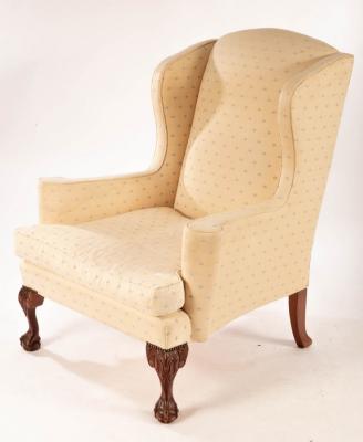 An upholstered wing back chair