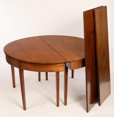 A mahogany dining table on square tapering