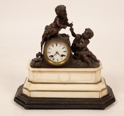 A mantel clock with putto surmount,