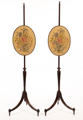 A pair of mahogany pole screens,