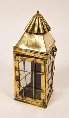 A brass lantern with glazed sides,