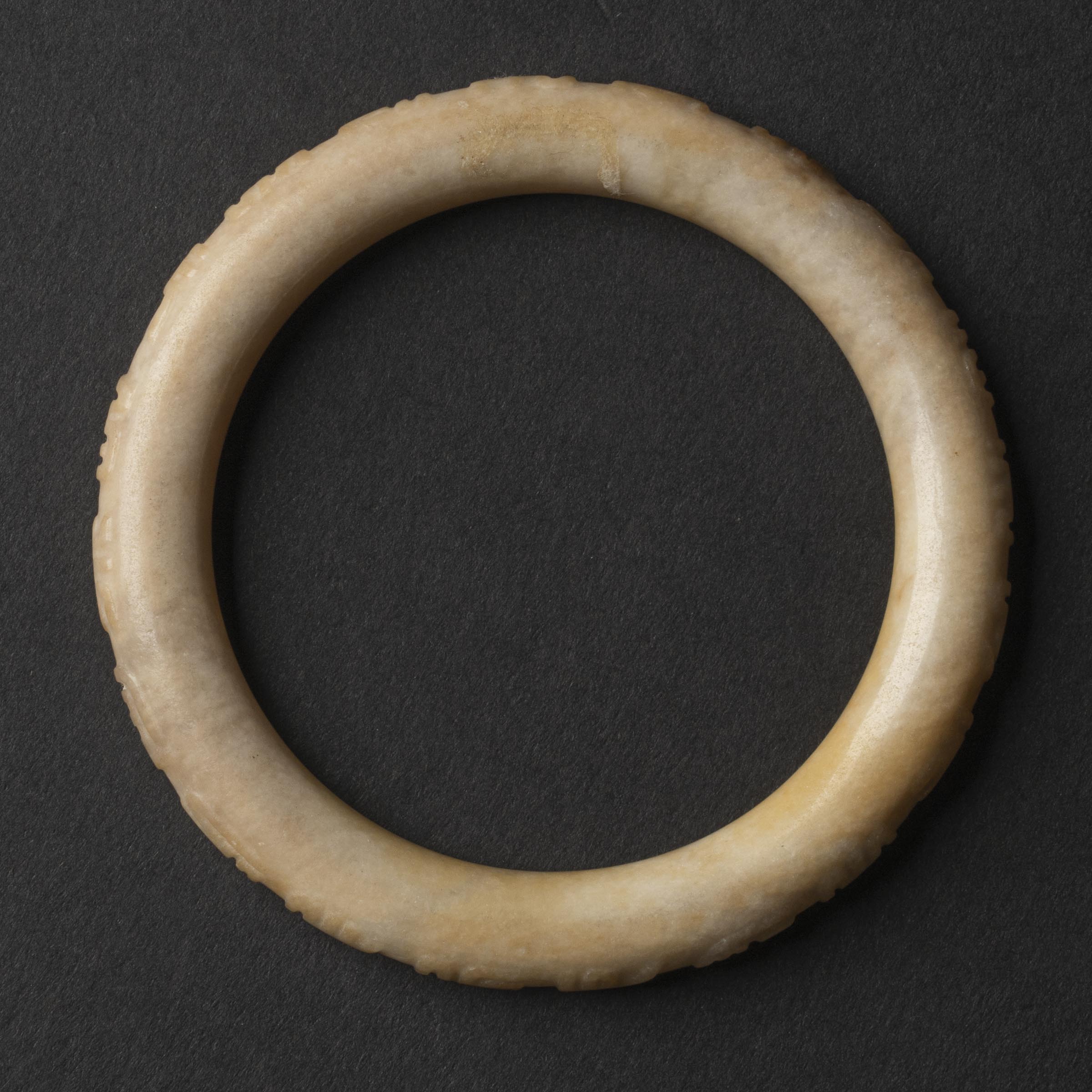 A White Jade Bangle with Inscription,