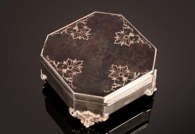 A square silver trinket box with canted