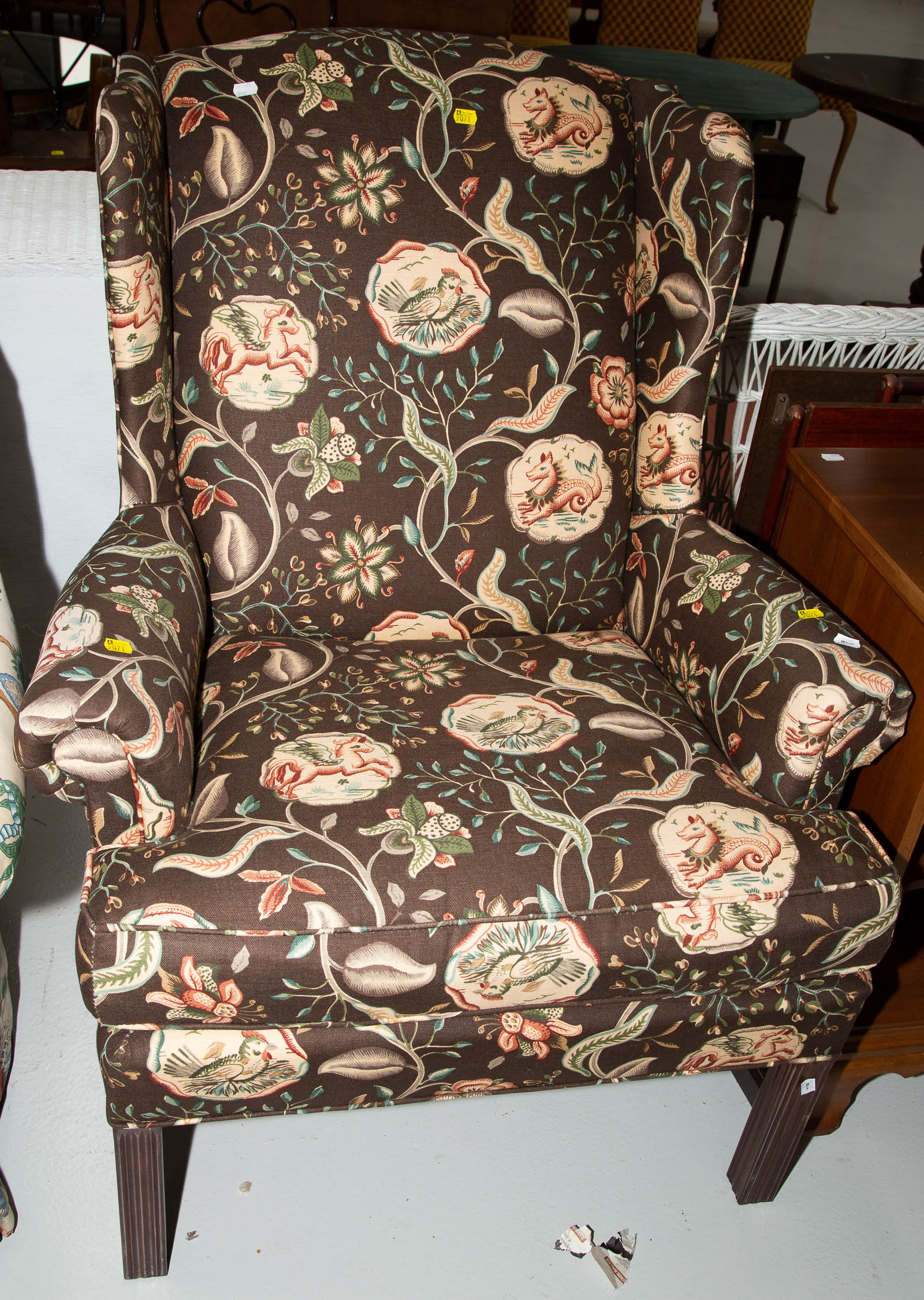 A FLORAL UPHOLSTERED WING CHAIR