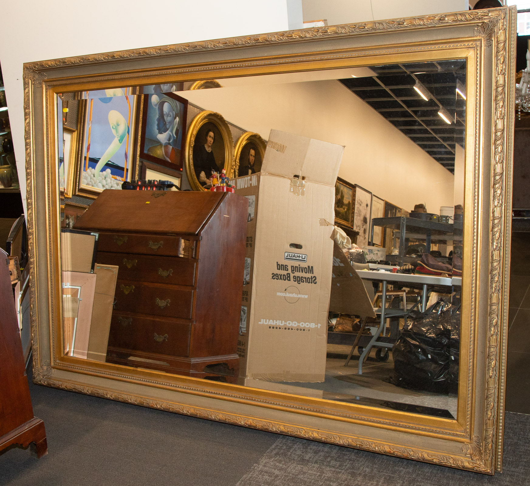 A LARGE GILT FRAMED MIRROR 60 in. H.,