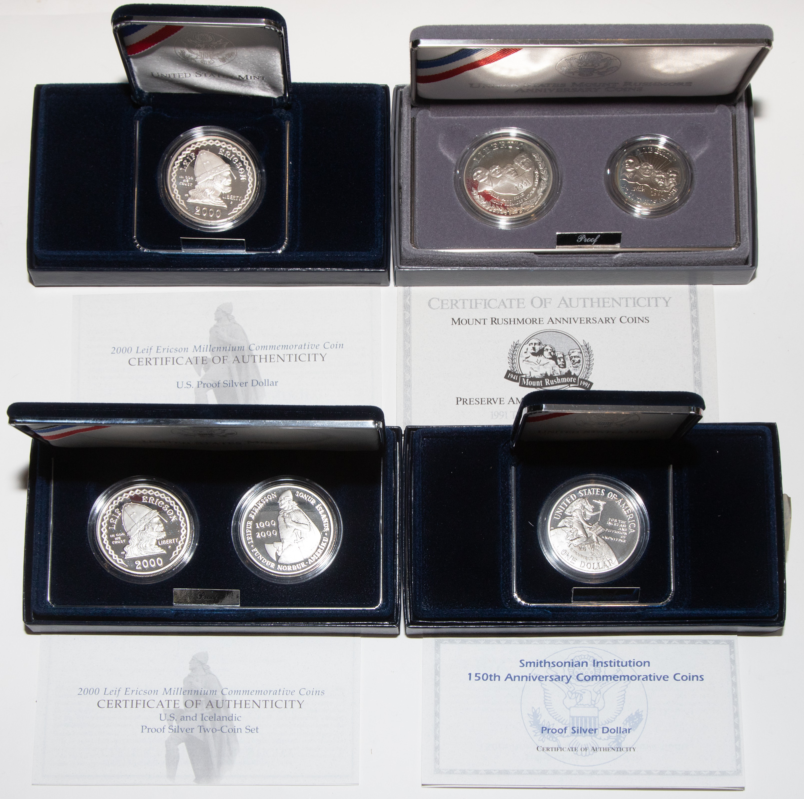 FOUR COMMEMORATIVE SILVER SETS