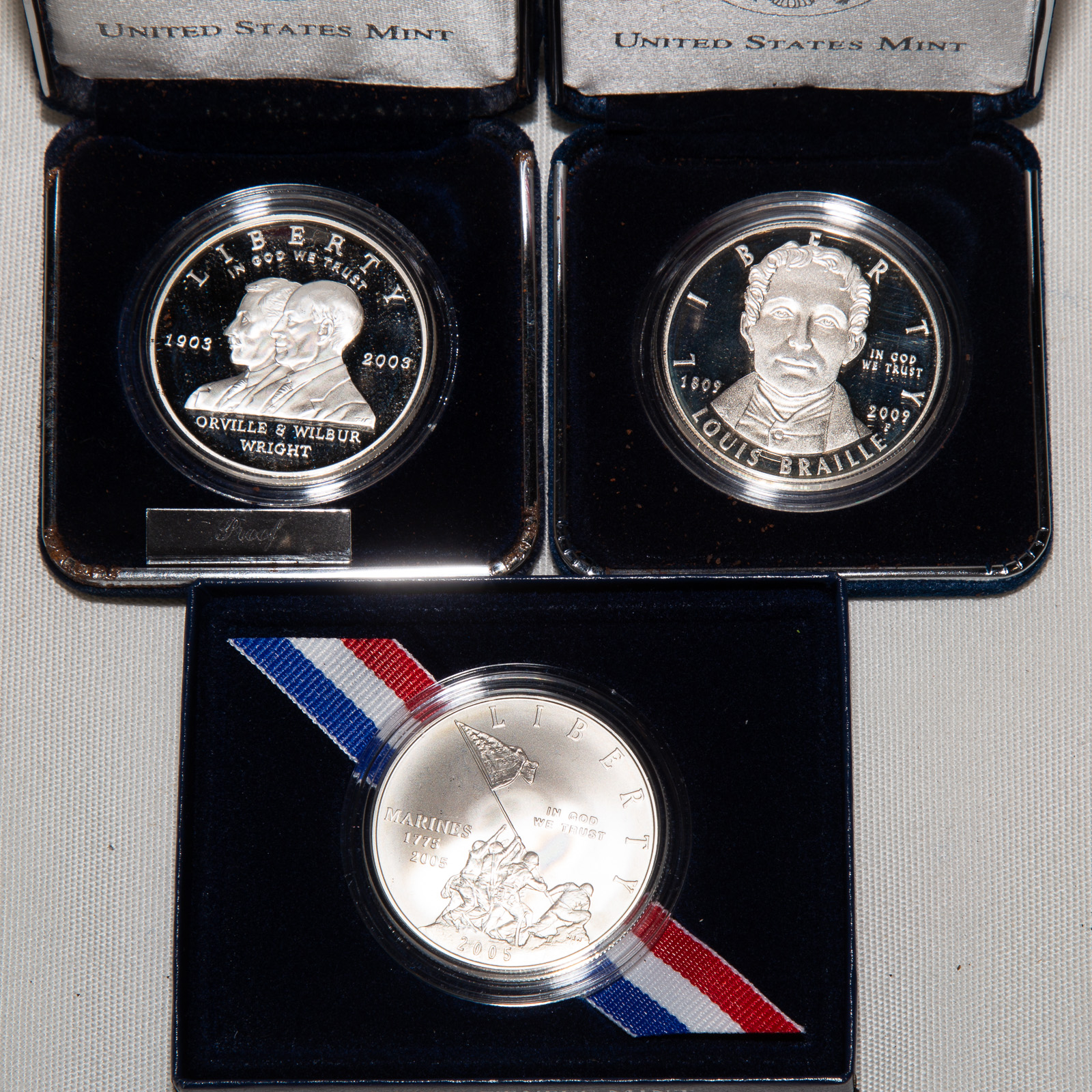 THREE COMMEMORATIVE SILVER DOLLARS