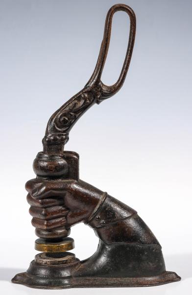 A LARGE FIGURAL CLENCHED FIST IRON