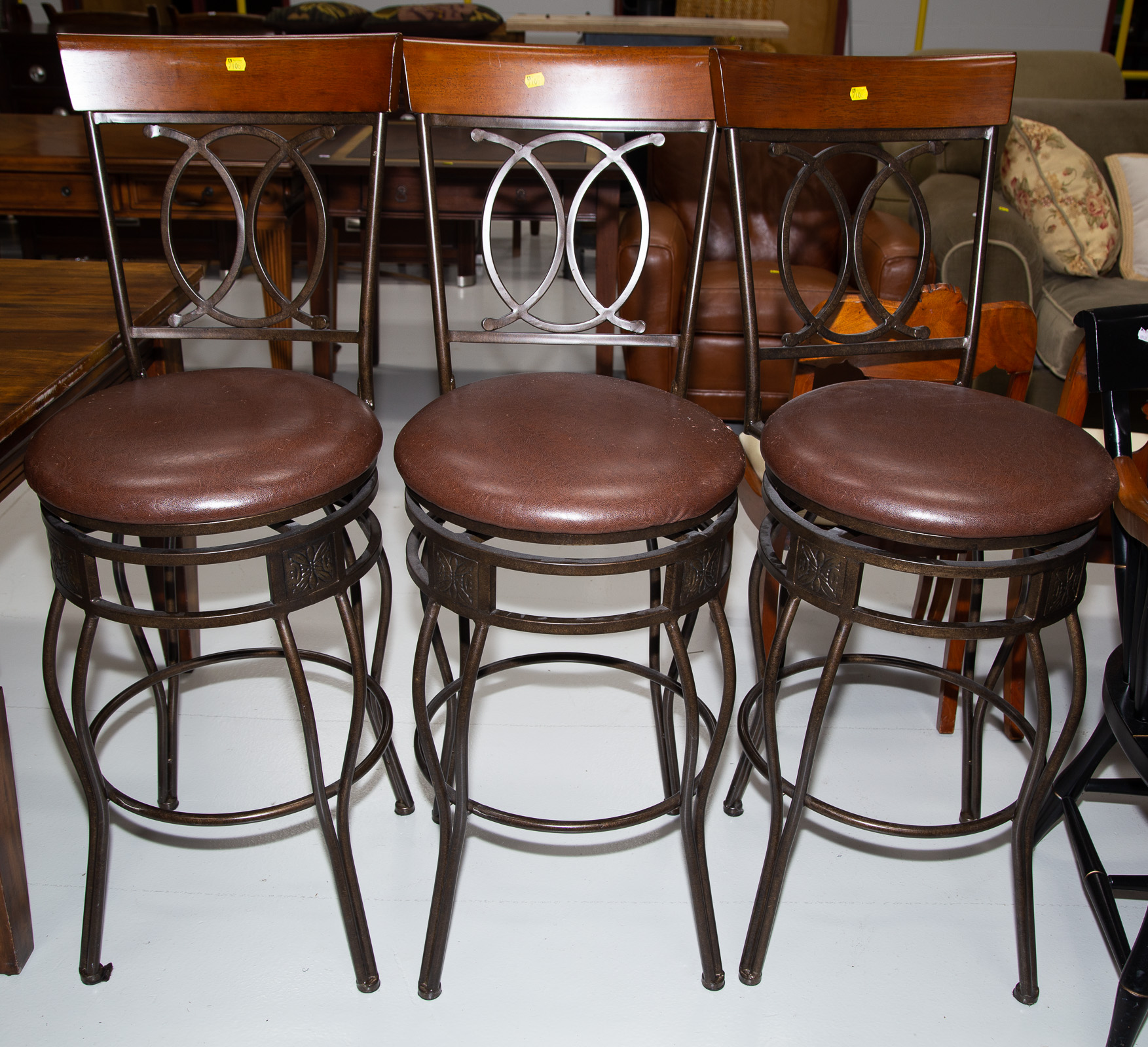 THREE BAR STOOLS With patinated