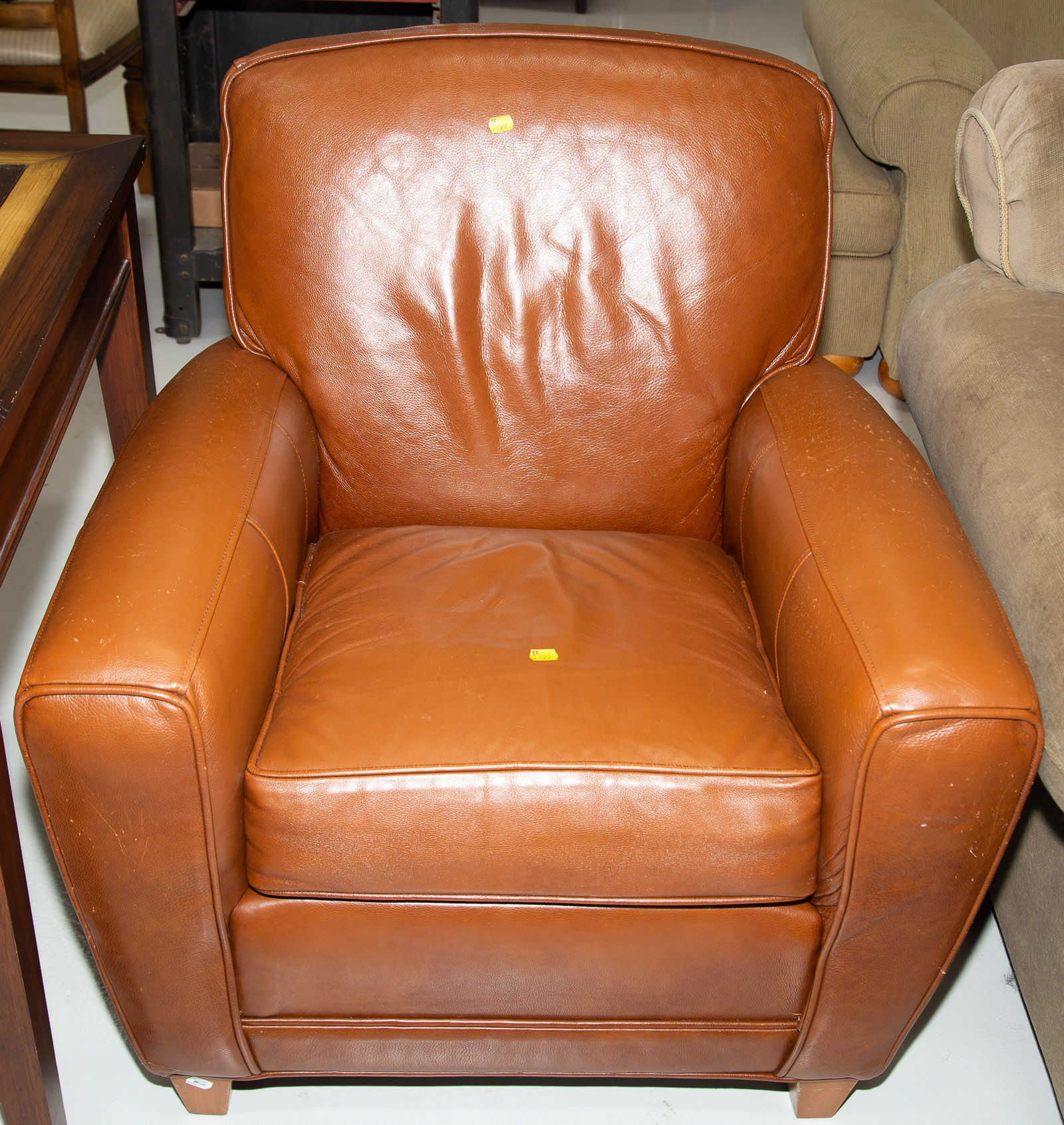AN ETHAN ALLEN BROWN LEATHER CHAIR .