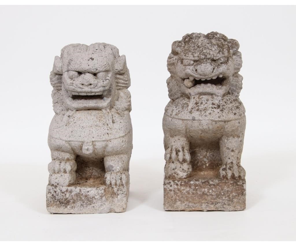 Two similar cast stone seated foo dogs,