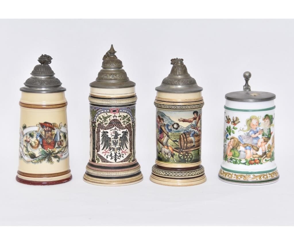 Four colorful German steins with